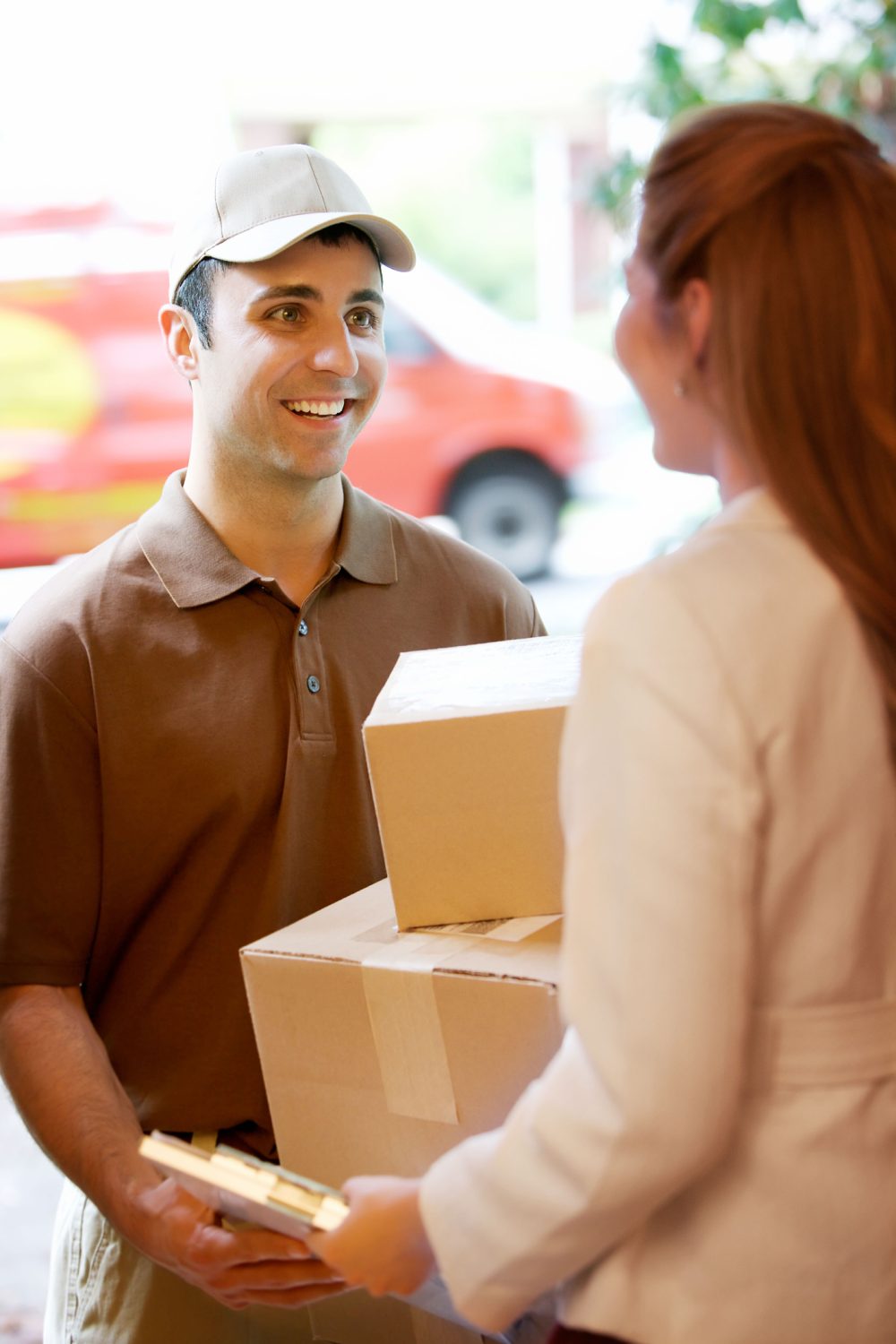 Courier delivering packages to home owner.